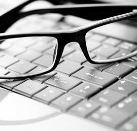 glasses on a laptop keyboard